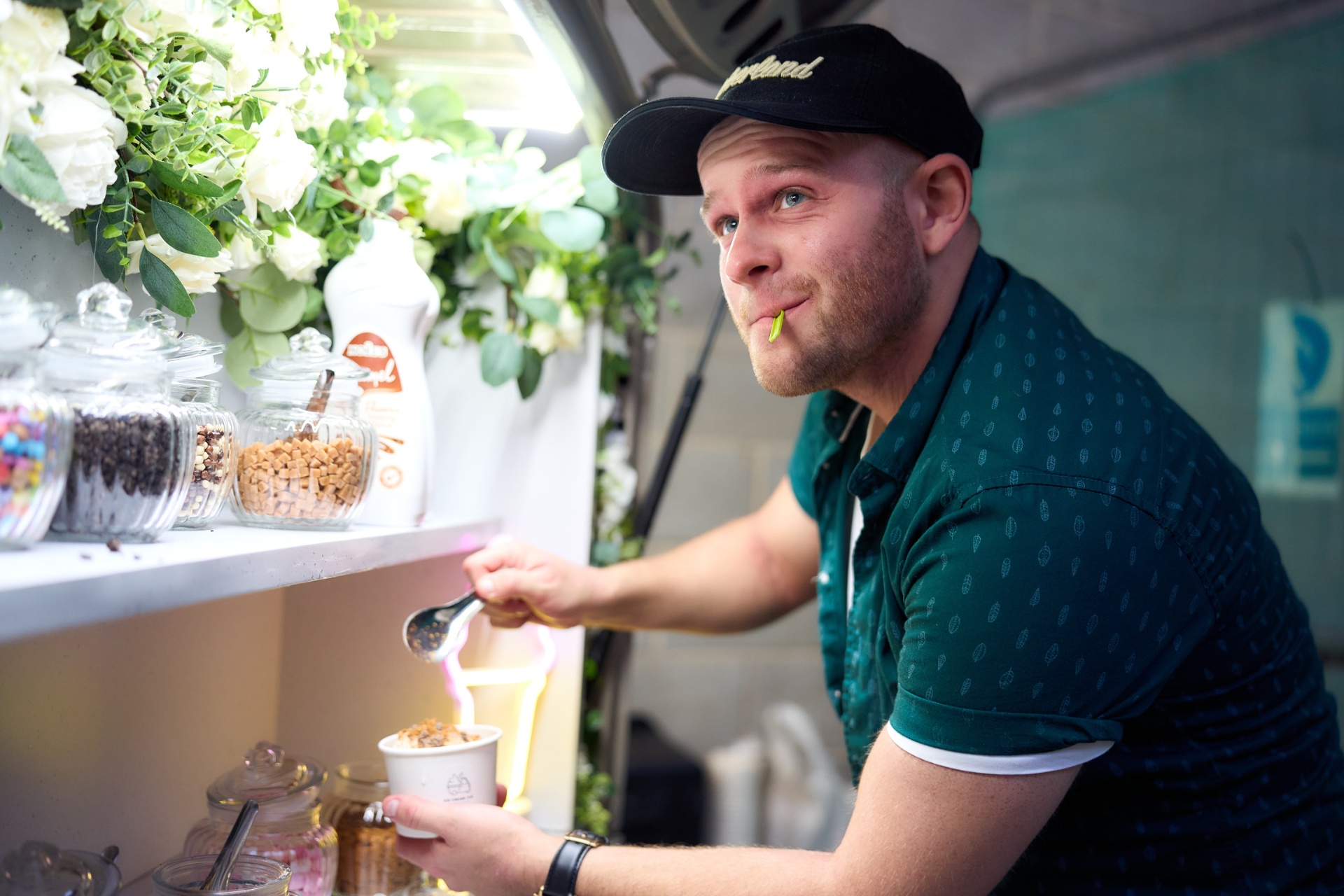 Attendant inside the tuk-tuk serving branded ice cream