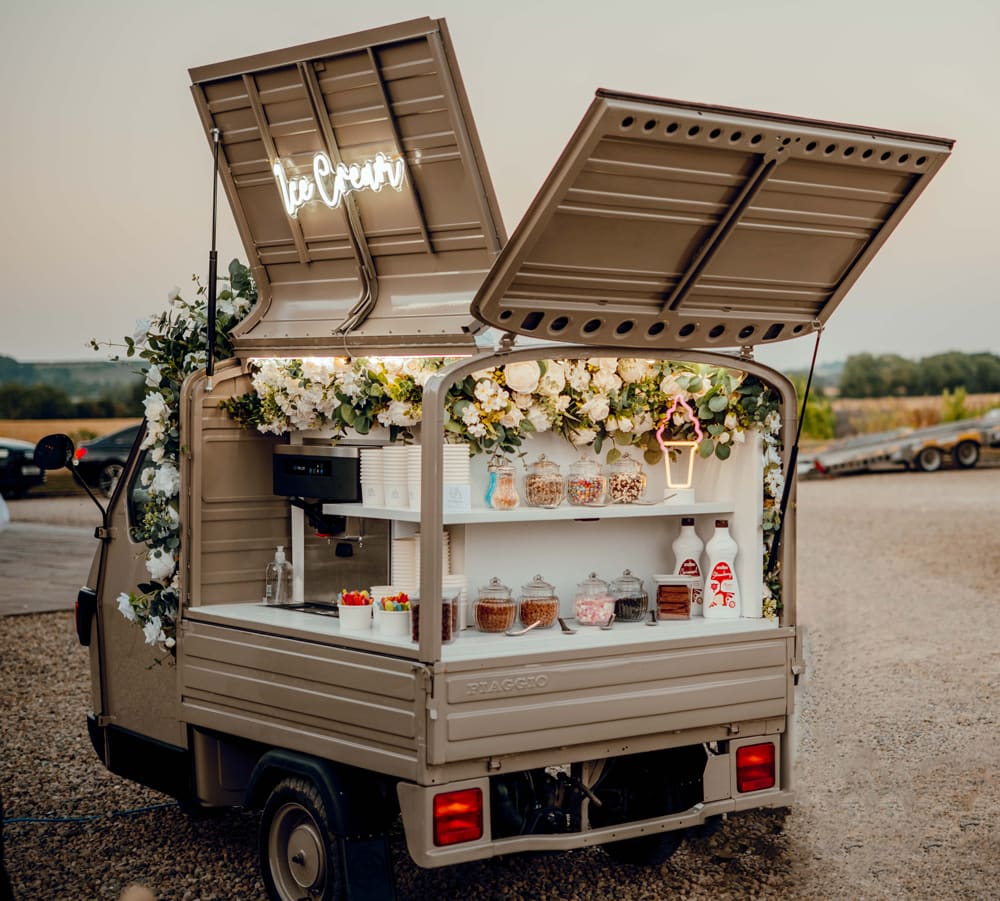 The vintage floral Ice Cream Tuk set up for guests at a wedding venue