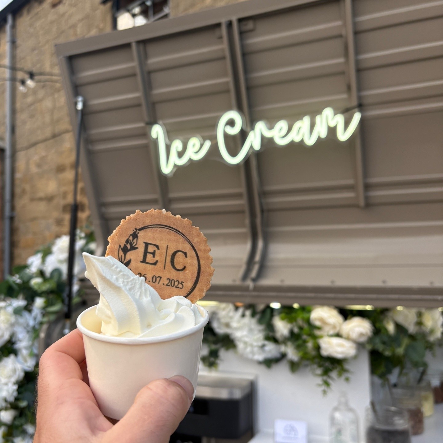 Branded E|C ice cream cup and cookie wafer in front of the vintage tuk-tuk