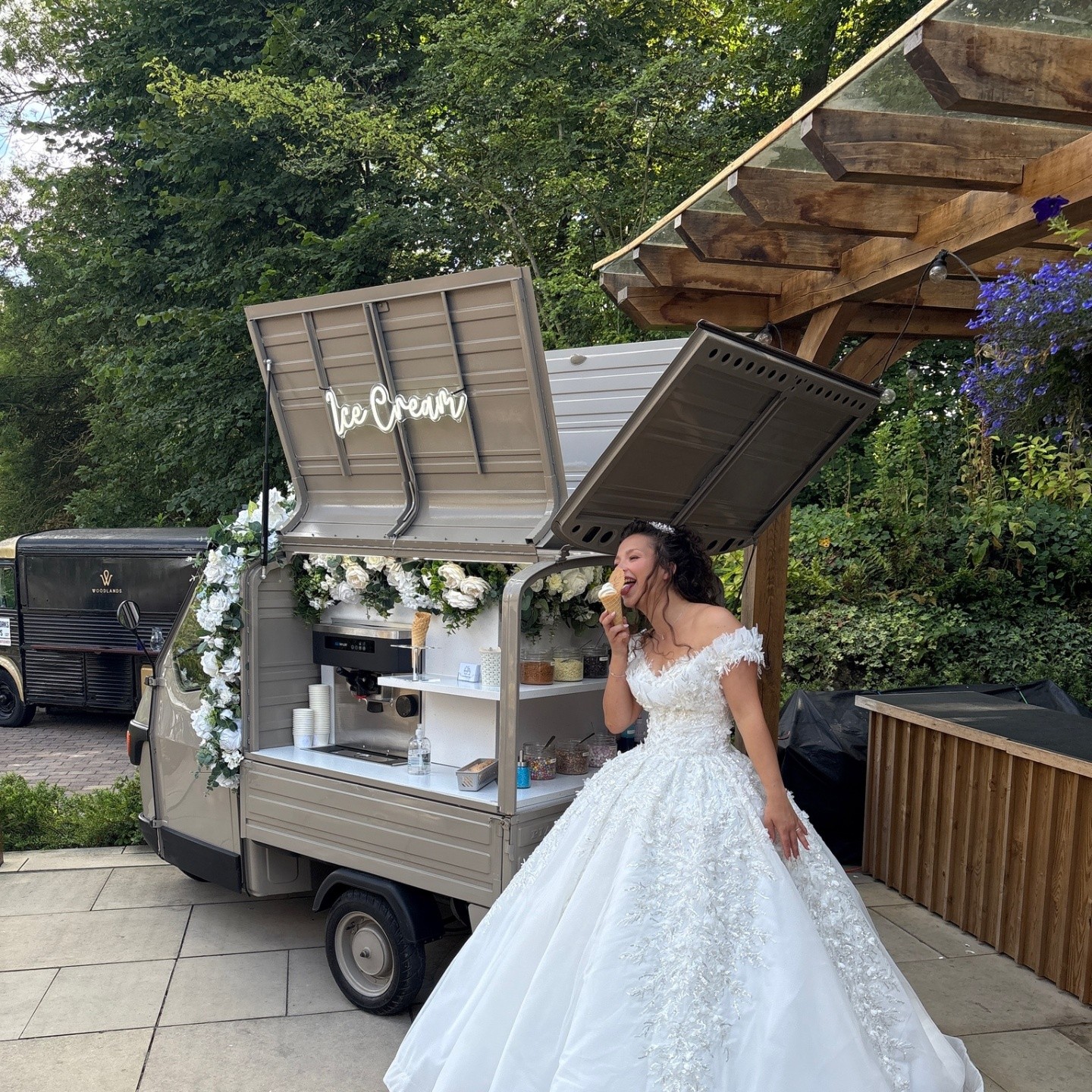 Bride enjoying a soft-serve ice cream cone beside the vintage tuk-tuk